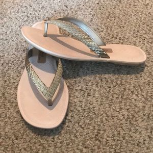 Gold tone flip flops